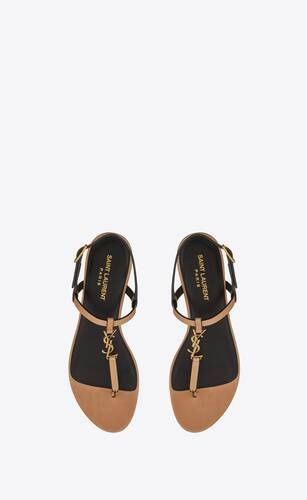 Flat sandals with a t-strap arch band and an adjustable buckle, decorated with metal CASSANDRE on... | Saint Laurent Inc. (Global)