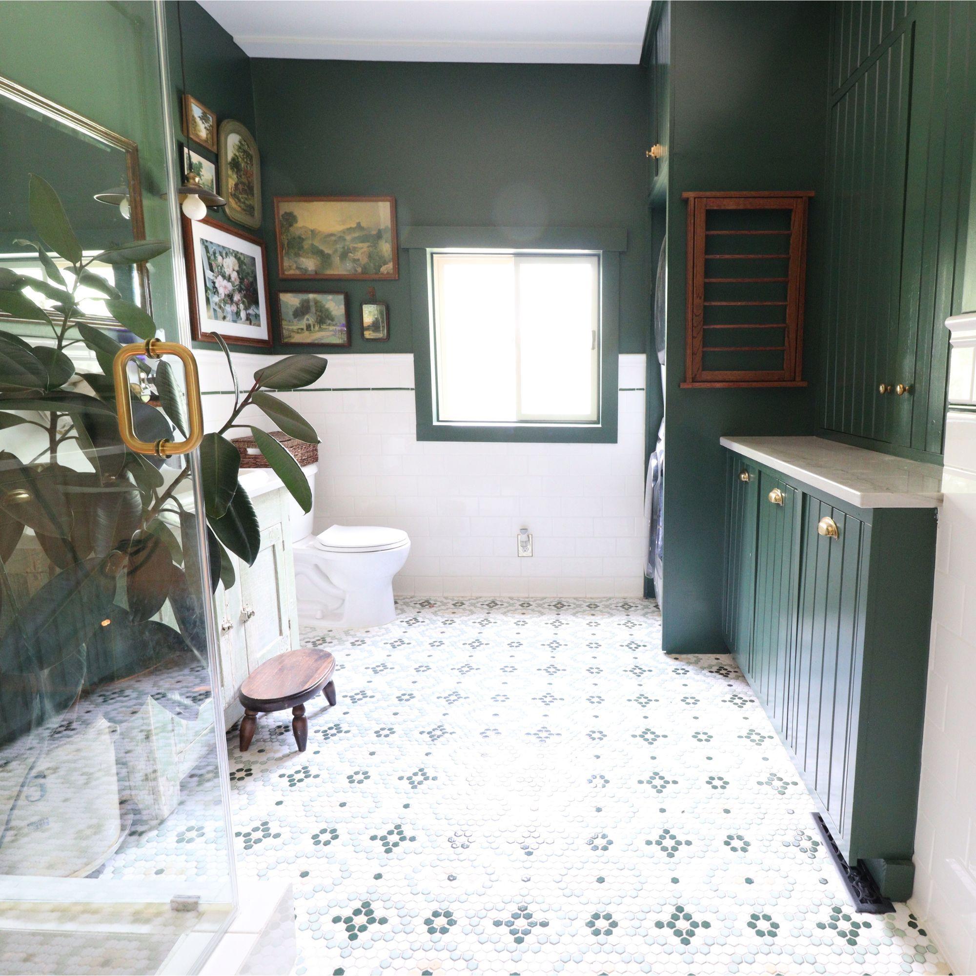 Dark green cabinets, mosaic tile floors, brass details, and plenty of storage made this bathroom + laundry combo beautiful. 

 #LTKHome