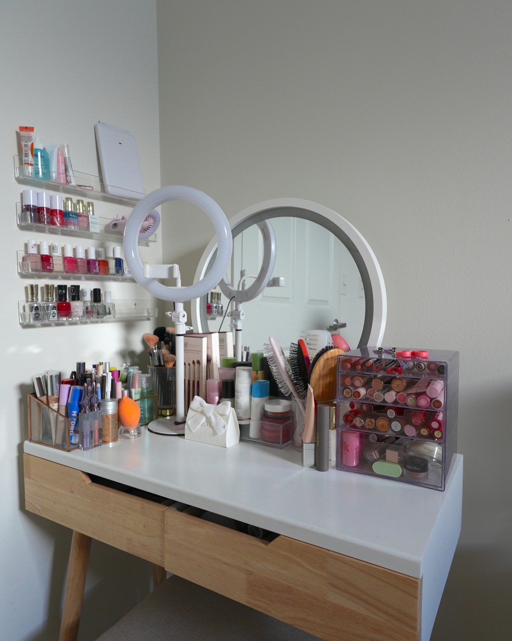 This vanity is where I get ready every morning! The white vanity table has plenty of drawers for storage, and I use clear acrylic organizers to keep all my makeup in view. A round tabletop mirror with built-in lighting makes getting ready so much easier with an extra desktop ring light for when I’m filming. I keep a few of my most-used products right on top for a clean but functional look.

#LTKHome #LTKBeauty #LTKFindsUnder100