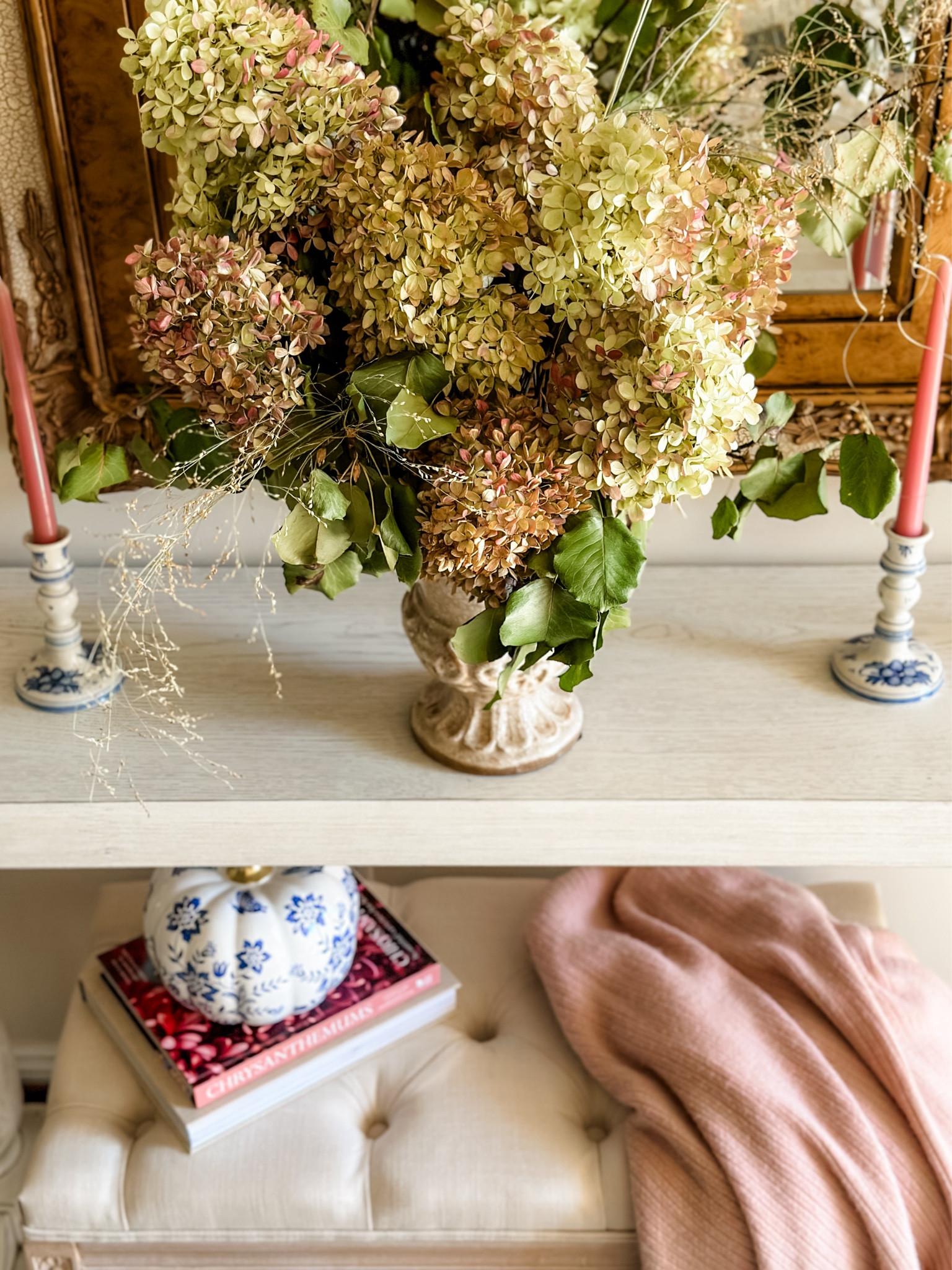 Front entryway decor 🍂

Candles 
Pumpkin decor 
Fall seasonal decor 
Console table 
Foyer table 
Bench 
Coffee table books 
Blanket 