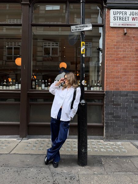 Oversized white shirt, wide leg tracksuit jogger bottoms, leather loafers, vest top, leather bag, sunglasses

#LTKSeasonal #LTKeurope #LTKstyletip