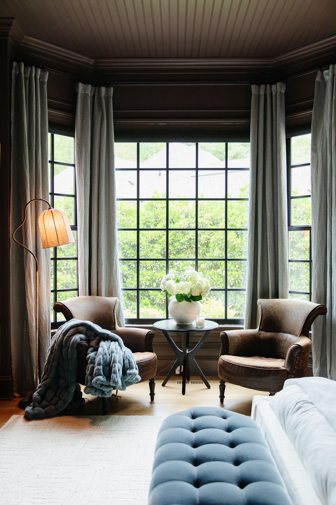 Moody Modern Traditional Primary Bedroom 🖤

Linen blackout curtains, Lola blanket, leather wingback armchair, black round end table, floor lamp, white vase, area rugg

#LTKhome #LTKSeasonal