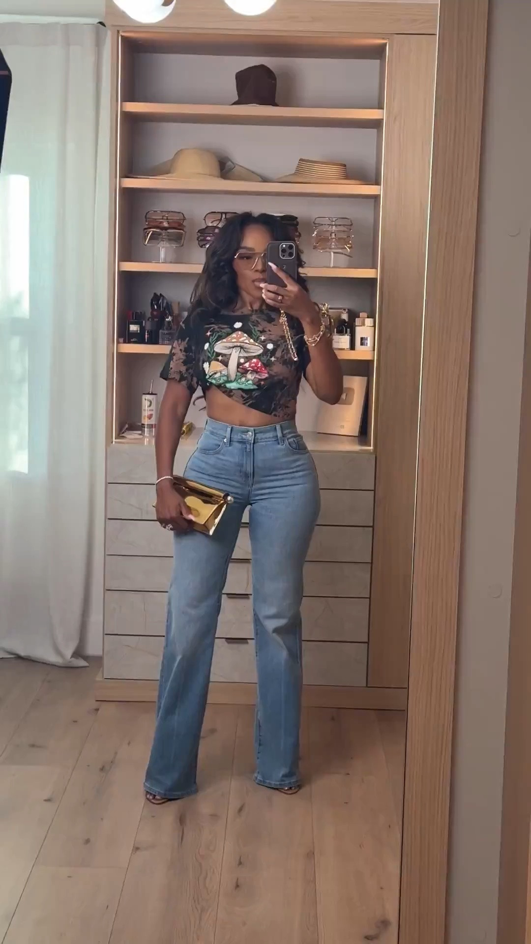 Hi babes! 🤎

Okay this graphic crop + denim combo is SUCH a fun switch-up from basic everyday outfits while still being insanely wearable. The vintage-inspired mushroom graphic gives it that cool-girl edge, and pairing it with classic light wash denim keeps the whole look balanced and easy to style.

This is the kind of outfit that looks effortless but still feels styled because the accessories completely elevate it. Added the metallic clutch + layered jewelry to bring in that luxury-inspired contrast and make the casual pieces feel way more elevated.

A statement tee styled with good denim is always worth buying because you can rotate it with cargos, leather pants, shorts, skirts, or blazers year-round. Cost per wear on pieces like this ends up being SO good.

Where to wear this:
• Concert nights
• Casual dinner dates
• Weekend errands
• Girls night
• Casual drinks
• Travel days
• Everyday summer outfits

Everything is linked below ✨

xx Kira | IG: KirasFashionFinds

5’4 | 140LBS | 34D-27-40 | size small | jeans 27

#LTKootd #LTKgrwm #LTKPetite