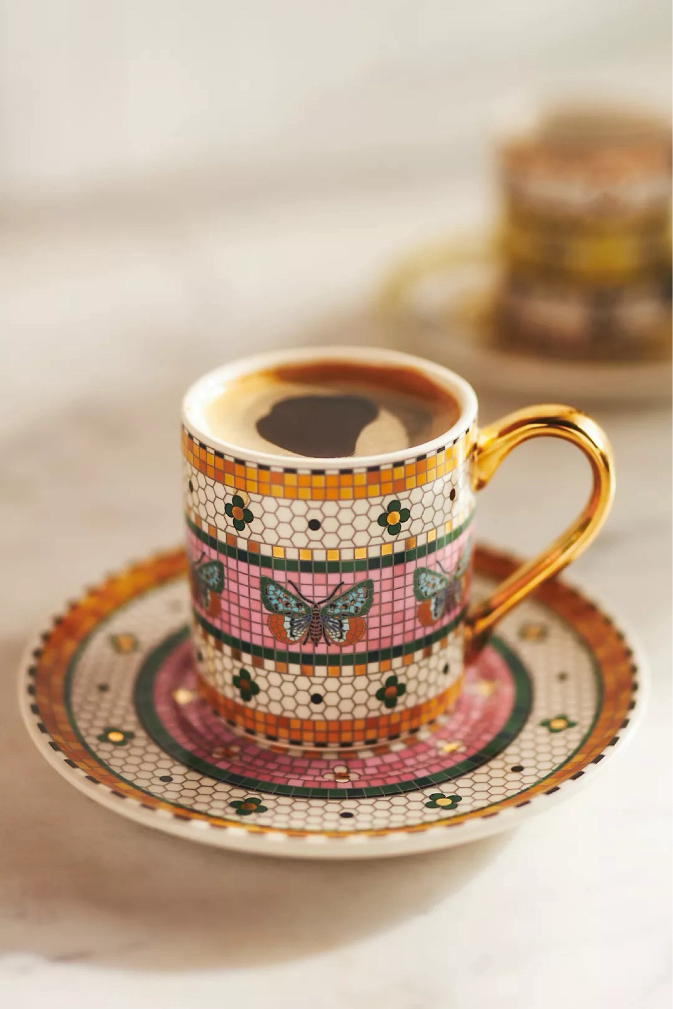 Say goodbye to ordinary dinnerware and décor – and hello to bold, mosaic-inspired motifs, and a touch of gold. Inspired by the charming sidewalk cafes of Parisian boulevards, each eye-catching table topper and stunning accent in this collection is designed to make a statement. Perfect for a garden party or as a delightful hostess gift, these unique pieces bring Parisian charm into any home.

Complete your collection today and keep an eye out for fresh updates on this only-at-Anthro classic! Each set includes one espresso cup and one saucer, crafted from 24k gold-decaled glazed stoneware for a luxurious touch.

#LTKWedding #LTKParties #LTKHome