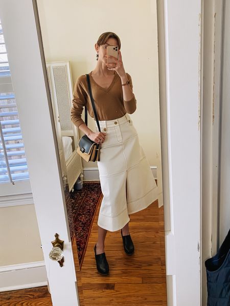 A light v-neck sweater and clogs make this white denim skirt work for cooler summer days. 

#LTKshoecrush #LTKstyletip #LTKitbag