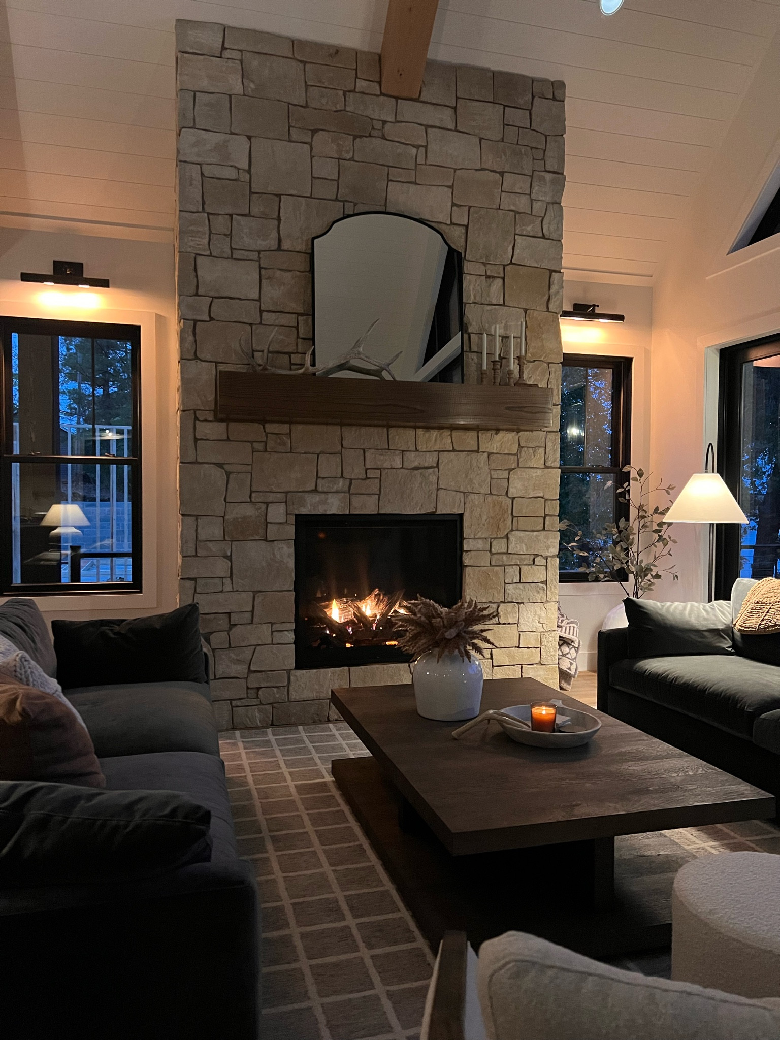 Cozy fall nights at the lake house. Our sofa fabric is Vance charcoal velvet. 
Living room, Loloi rug, plaid rug, fireplace decor 

#LTKstyletip #LTKhome