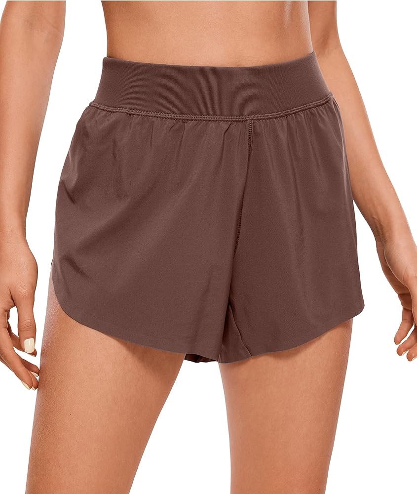 CRZ YOGA Mid Waisted Dolphin Athletic Shorts for Women Lightweight High Split Gym Workout Shorts ... | Amazon (US)