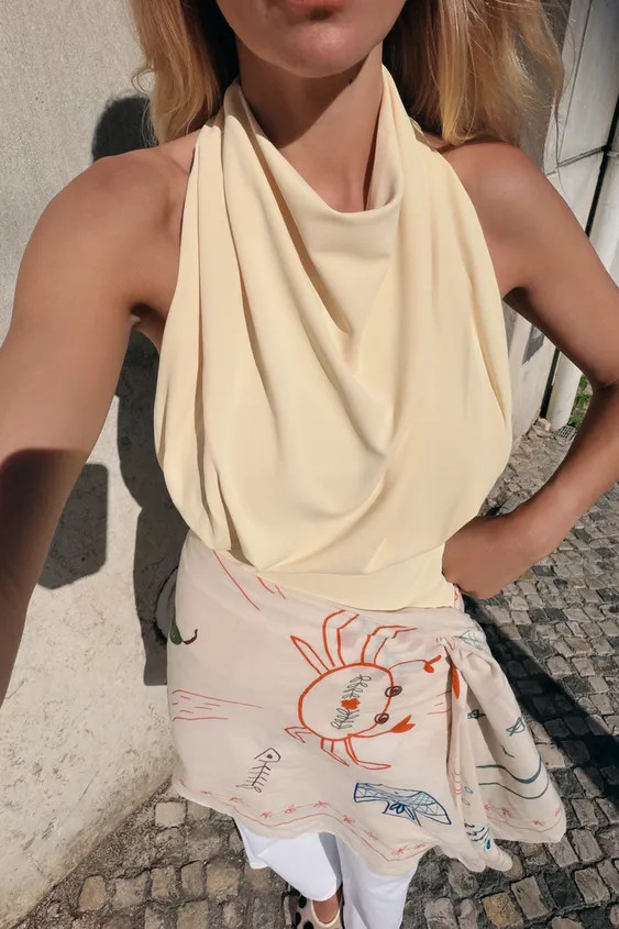 Draped neckline top with sleeveless design. Straight hem. Back button closure. | Zara US