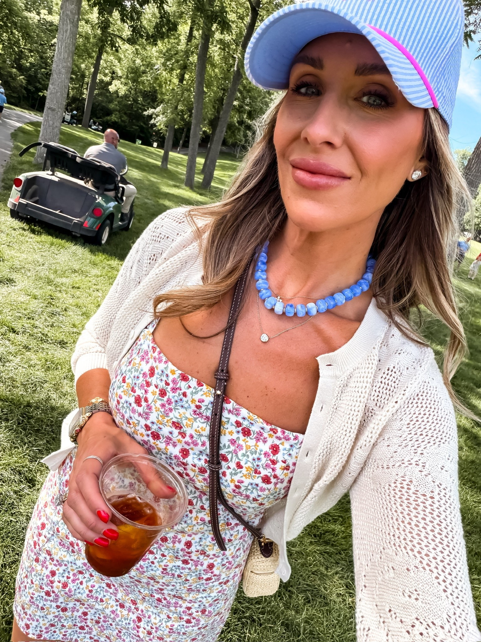 Country club chic with a little color. This floral dress, lightweight cardigan, and fun blue accessories made the perfect golf day outfit. Comfortable, cute, and easy to layer when the temperature changes throughout the day.

Golf outfit, country club style, floral dress, summer dress, golf tournament outfit, casual chic style, cardigan outfit, summer fashion, feminine style, resort wear, weekend outfit, TheMomInStyle

#LTKootd #LTKTravel #LTKSeasonal
