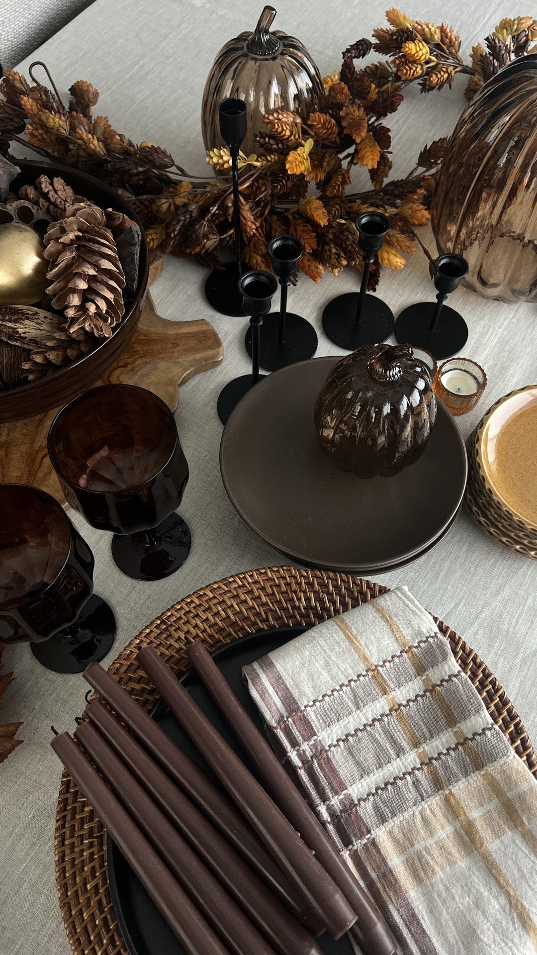 Fall tablescape decor, fall table setting, autumn hosting ideas, Thanksgiving table decor, chocolate brown dinnerware, golden ochre plates, brown glassware, amber wine glasses, plaid cloth napkins, black flatware, black candlesticks, chocolate brown taper candles, amber votive holders, smoky glass pumpkins, brown glass pumpkins, woven rattan chargers, neutral table runner, fall table garland, pinecone centerpiece, natural fall decor, layered place setting, moody fall table, warm fall color palette, elegant Thanksgiving table, modern fall hosting

#LTKHome #LTKSeasonal