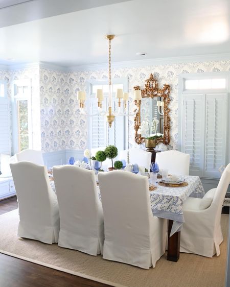 Dining room decor! White slip covered dining chairs, sisal rug, gold mirror. Blue and white grandmillennial chinoiserie wallpaper.

#LTKhome #LTKstyletip