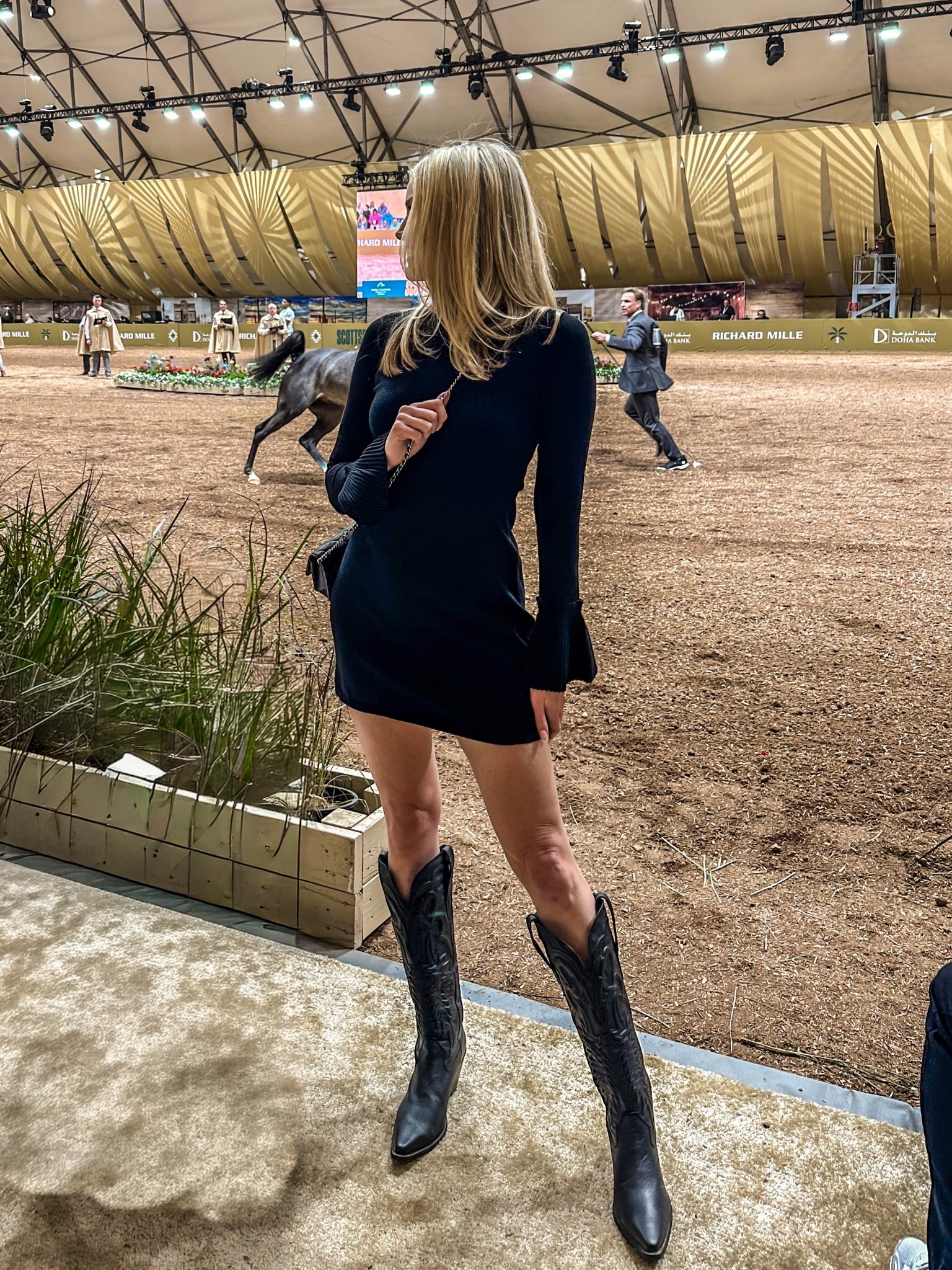 Western chic but make it elevated 🖤🐎

Wore this fitted black mini dress with classic black cowboy boots to the Arabian horse show at WestWorld and it was the perfect mix of polished + western glam. The subtle flare sleeve detail keeps it feminine, while the tall boots give that timeless rodeo-inspired edge.

This is one of those outfits that works for horse shows, country concerts, date night, or Scottsdale event season. Effortless, flattering, and very modern western.

Think: quiet luxury meets cowgirl core ✨

#westernstyle #cowgirlchic #scottsdalestyle #modernwestern #eventstyle #cowboyboots #blackminidress #equestrianstyle
