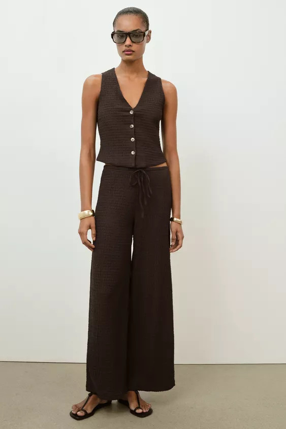 Vest-style top with V-neckline and sleeveless design. Textured fabric detail. Front button closur... | Zara US