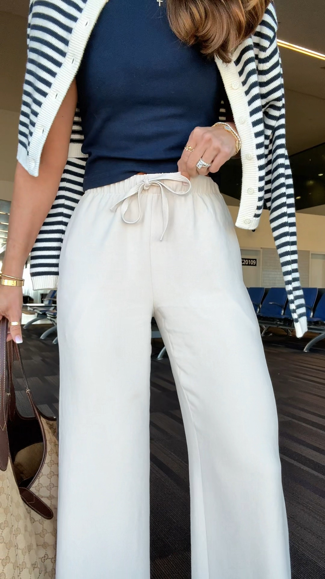 My travel outfit of the day! Aritzia The Lodge Pant - Crepette. Size XS regular, color ‘Metropolis Taupe’. Comes in short and tall, too. Wrinkle resistant with an elastic waist and high-rise. Aritzia t-shirt in XS. Aritzia striped cropped cardigan in 2XS. Jelly ballet flats are whole sizes only. I’m a 6.5 and sized down to a 6 per reviews. Business casual. Elevated casual. Workwear. Coastal outfit.

#LTKootd #LTKTravel #LTKPetite