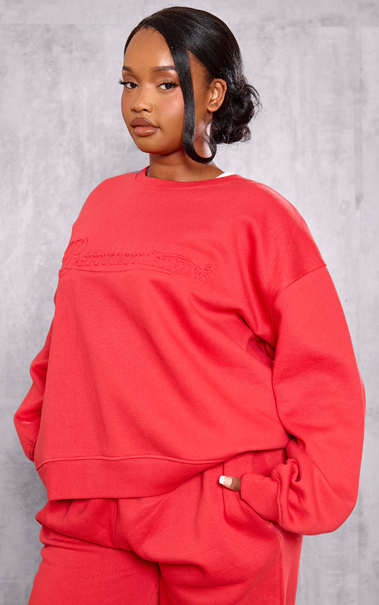 Plus Red Embossed Graphic Oversized Sweatshirt | PrettyLittleThing US