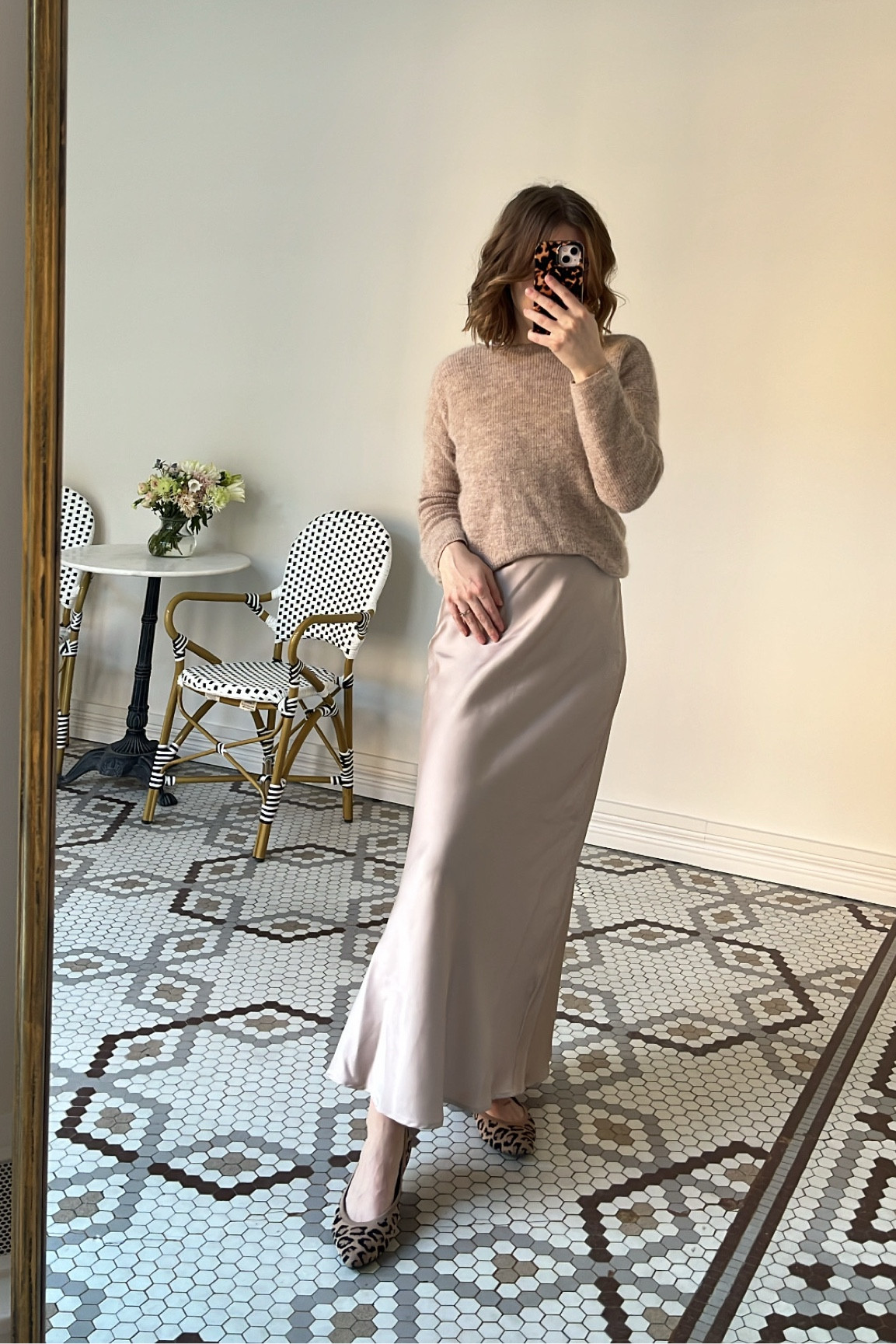 We love tonal looks for effortless work outfits year round. Pair a satin slip skirt with a light beige cardigan (the Gaspard from Sezane is my personal go-to, and I’m wearing it backwards here). Then, add interest with a pair of leopard print flats. It’s the perfect balance of comfy and elevated for office wear. -Cassie, MCO Content Coordinator

#LTKWorkwear #LTKStyleTip #LTKSeasonal