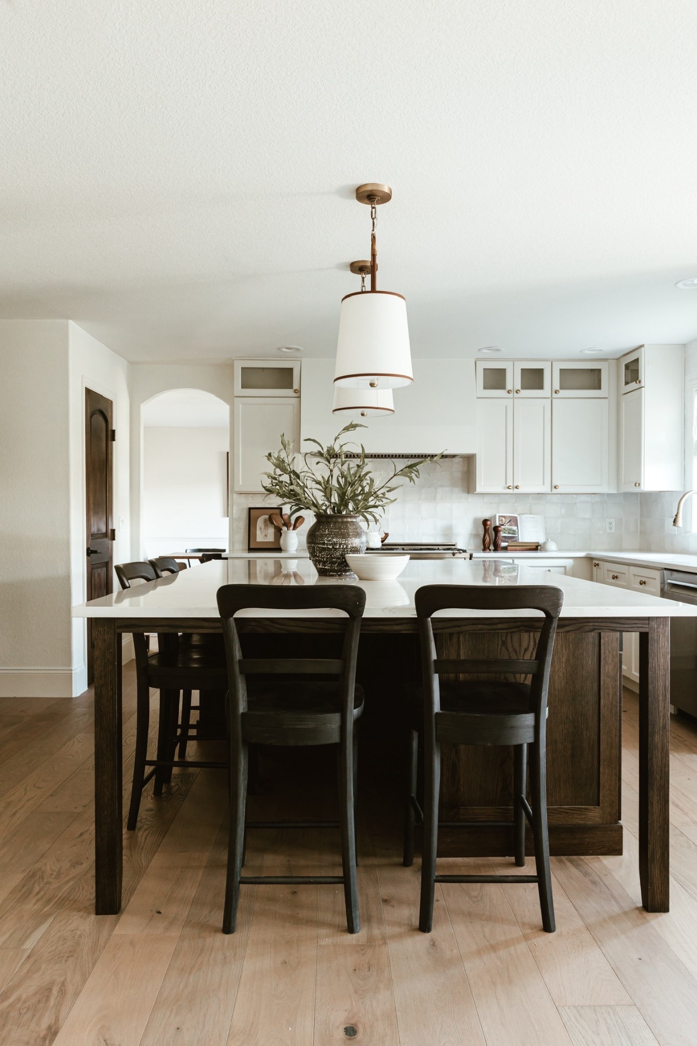 These classic wood dining chairs offer a timeless look in your kitchen. The beautiful pendant lights really elevate the dining area with the mixed metals. Love how this dining room turned out. 

#LTKFamily #LTKHome #LTKStyleTip