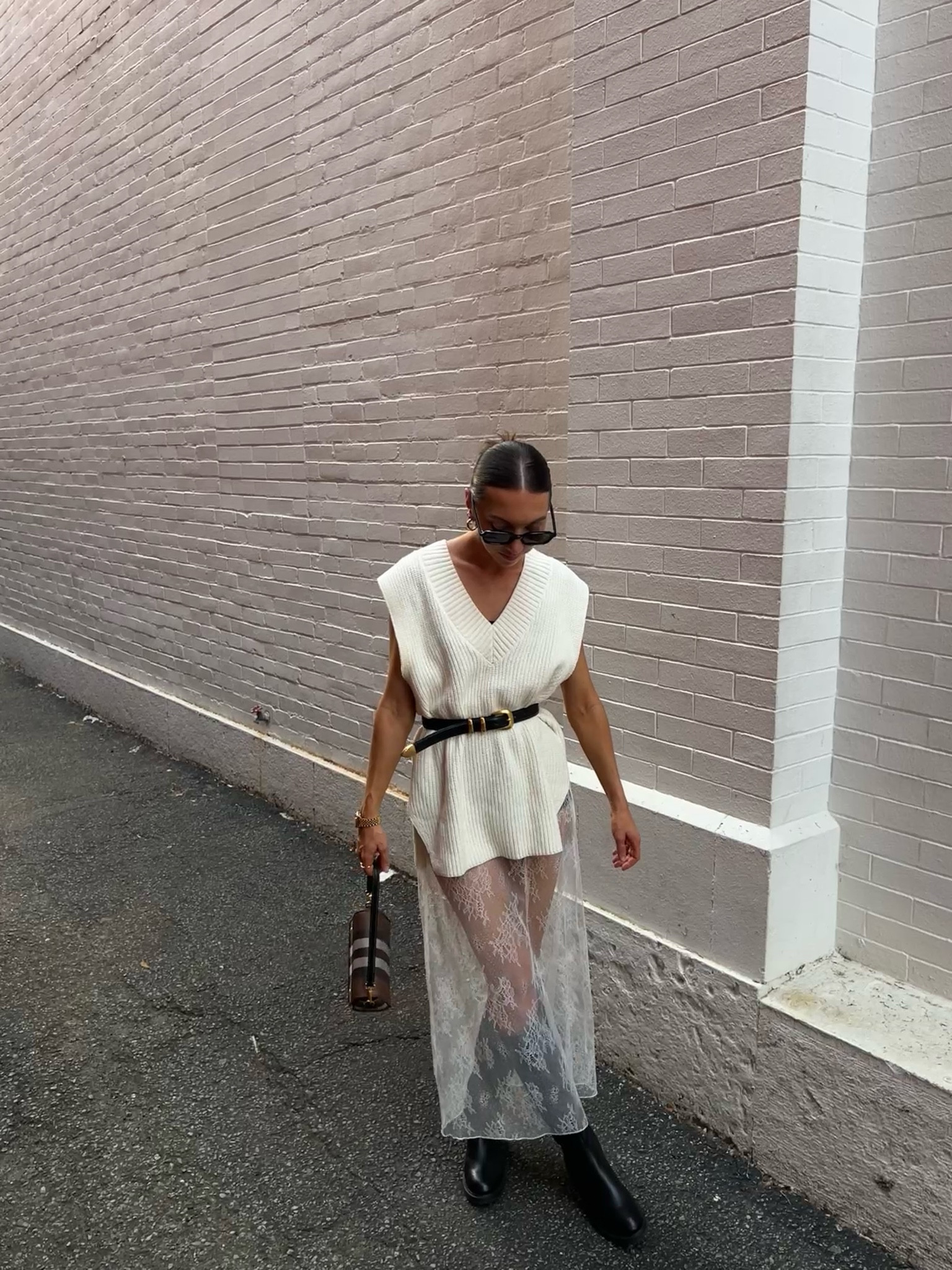 Transitional Fall Outfit ft. A white lace skirt, an oversized sweater vest and a black belt. Tall black boots and a Burberry purse

#LTKFindsUnder100 #LTKSaleAlert #LTKStyleTip