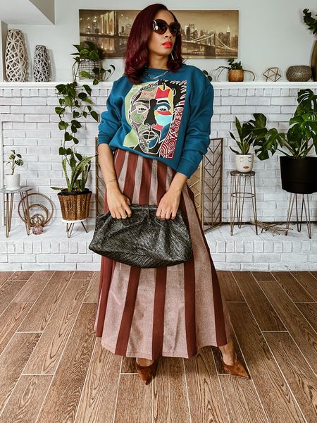 Mixing prints in this Anthropologie skirt and Target Black History Month sweatshirt. This look would be great with heels or flat boots but the skirt is long, and on sale! Wearing a Small in the sweatshirt and XS in the skirt. 

#LTKstyletip #LTKfindsunder100 #LTKsalealert