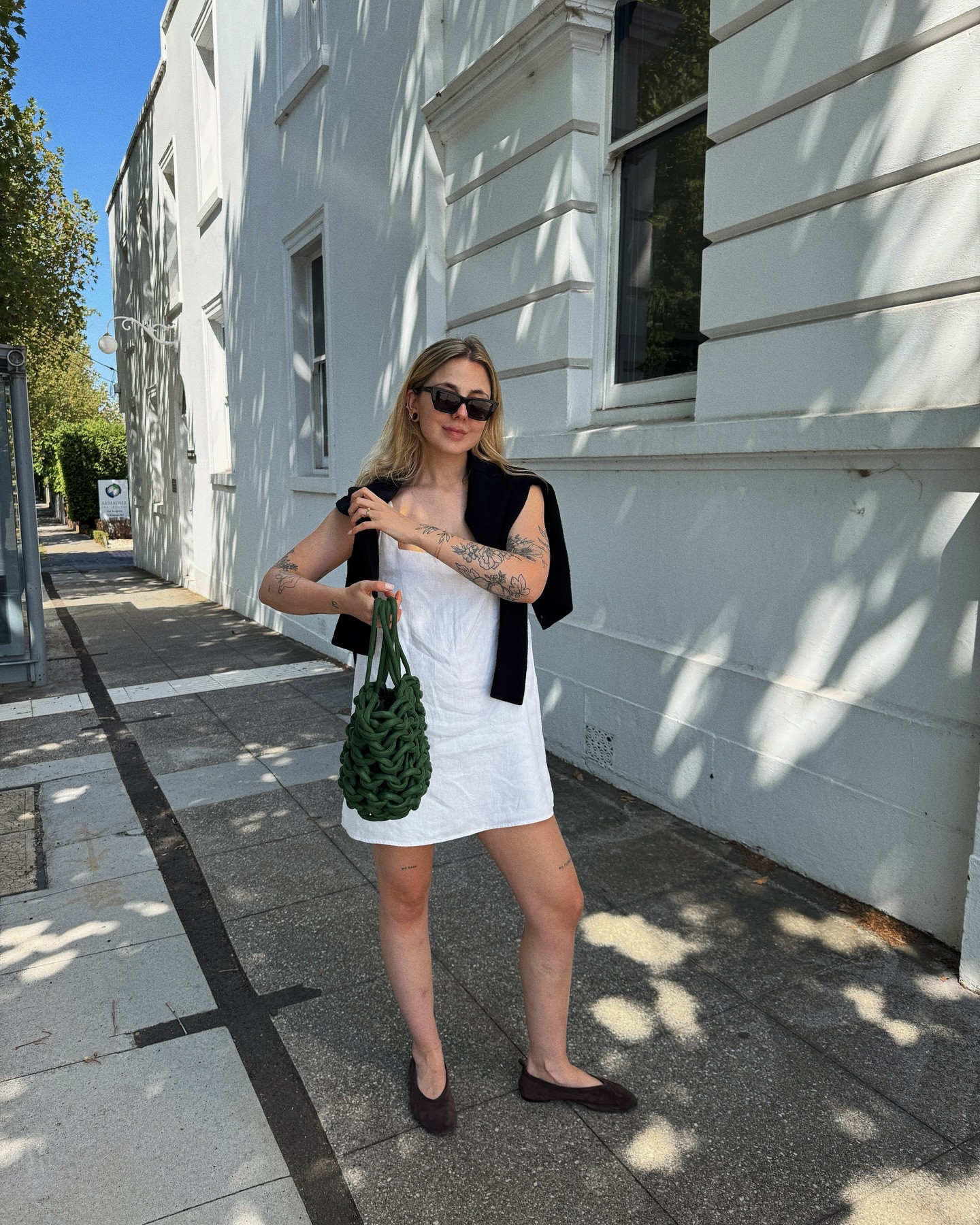 Goes to Australia, takes photo against white wall