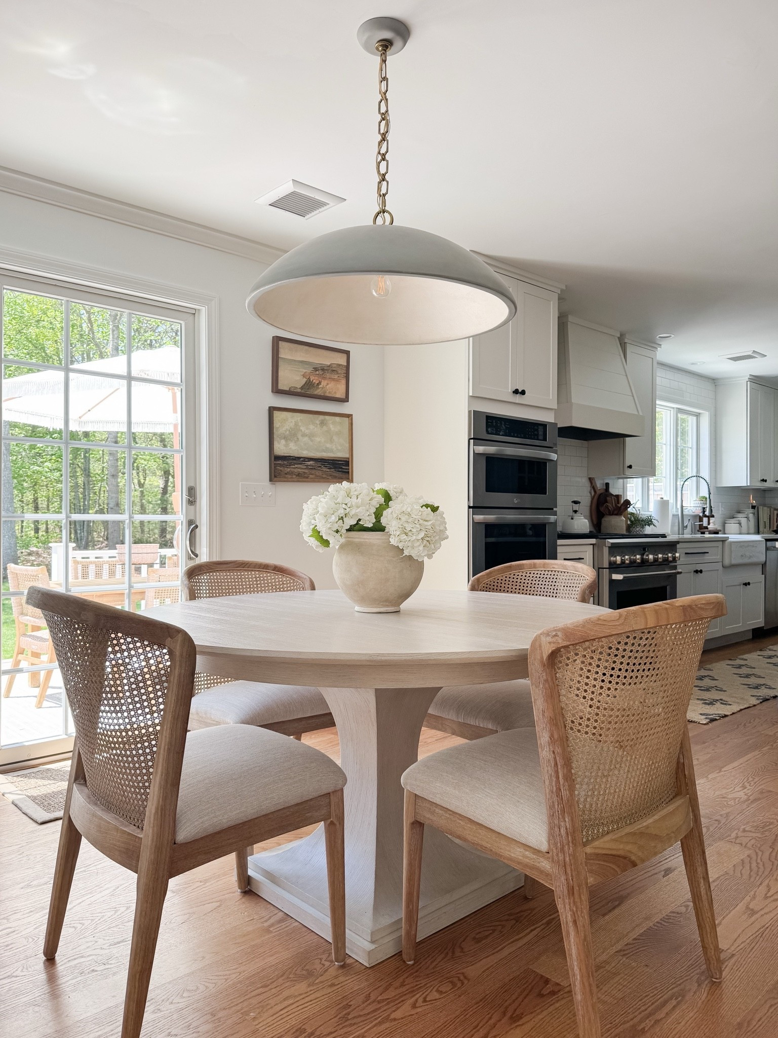 coastal dining room decor, round wood dining table, woven dining chairs, faux hydrangea centerpiece, neutral dining room styling, coastal interior decor, light coastal home, neutral dining room inspiration, sherricalnanhome

#LTKHome