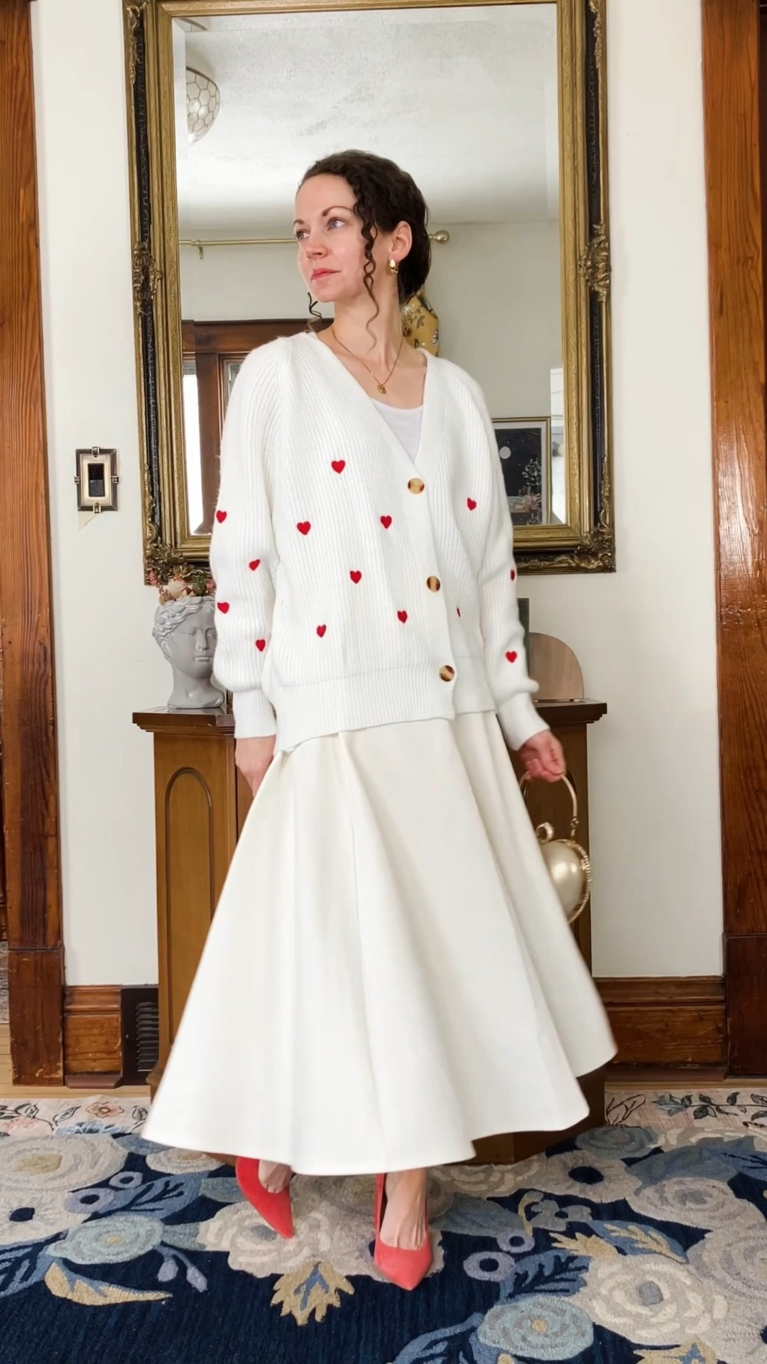 A modest Valentine’s Day outfit!
White and red embroidered heart cardigan from Chicwish. 
White cropped tank top from Amazon. 
White skirt from Chicwish. 
Jeweled heart bag from Chicwish. 
Red heels from Nine West (linking similar, mine are old). 
Gold and white topaz earrings from Peachmind. 
Gold and diamond necklace from Oak and Luna. 
Petite outfit. Neutral outfit. Modest outfit. Valentine’s Day outfit.  

#LTKOver40 #LTKPetite #LTKValentine