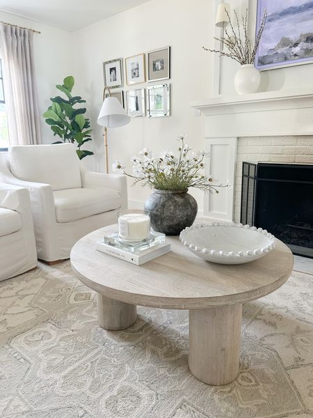 White washed round coffee table, coffee table decor and styling, neutral ivory and beige area rug, white accent chair, faux tree, home decor 

#LTKstyletip #LTKsalealert #LTKhome