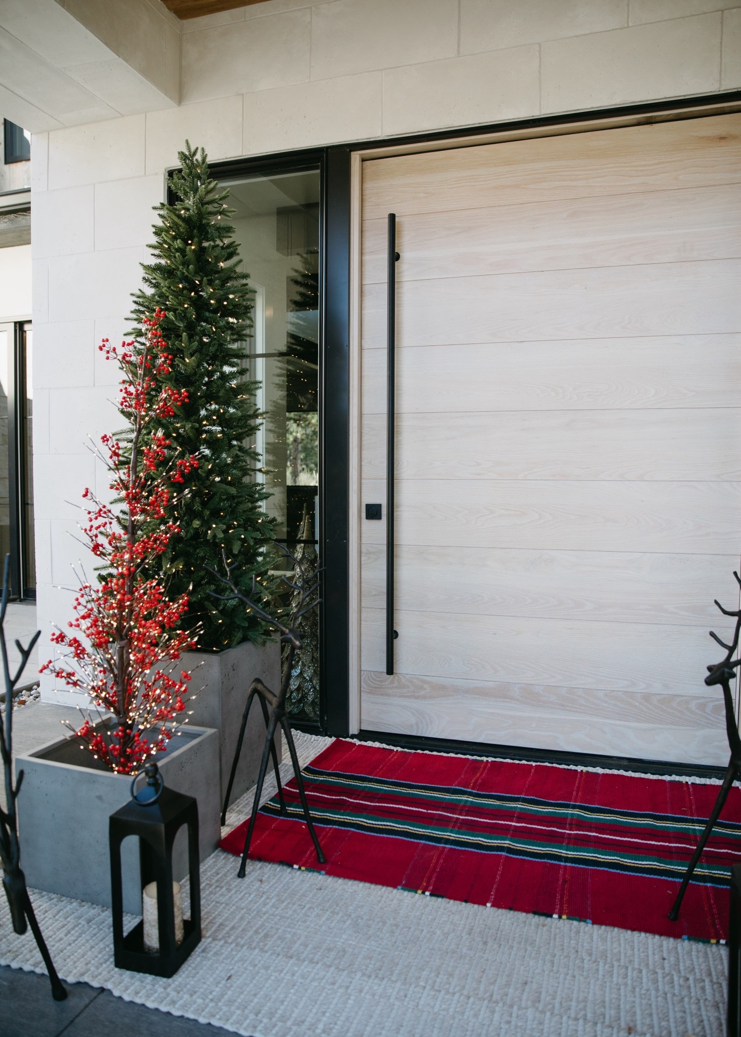 Christmas front porch details. The layered rug look is my favorite! This is the Stewart Plaid rug from Pottery Barn. I created some dimension with the trees by using the Mission Planters for extra height. Love how the Christmas porch turned out this year!

#LTKHoliday #LTKHome #LTKSeasonal