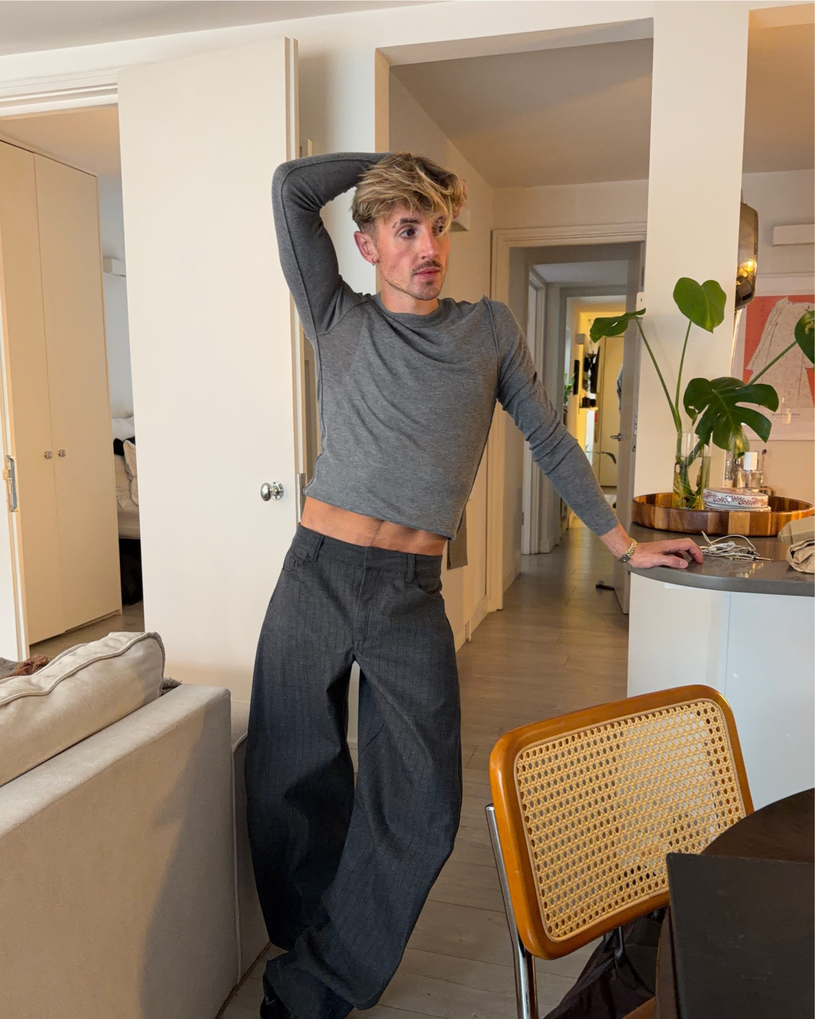 Men's grey knit and striped grey trousers layered with a white vest and black boots

#LTKmens #LTKFashionMonth #LTKautumn