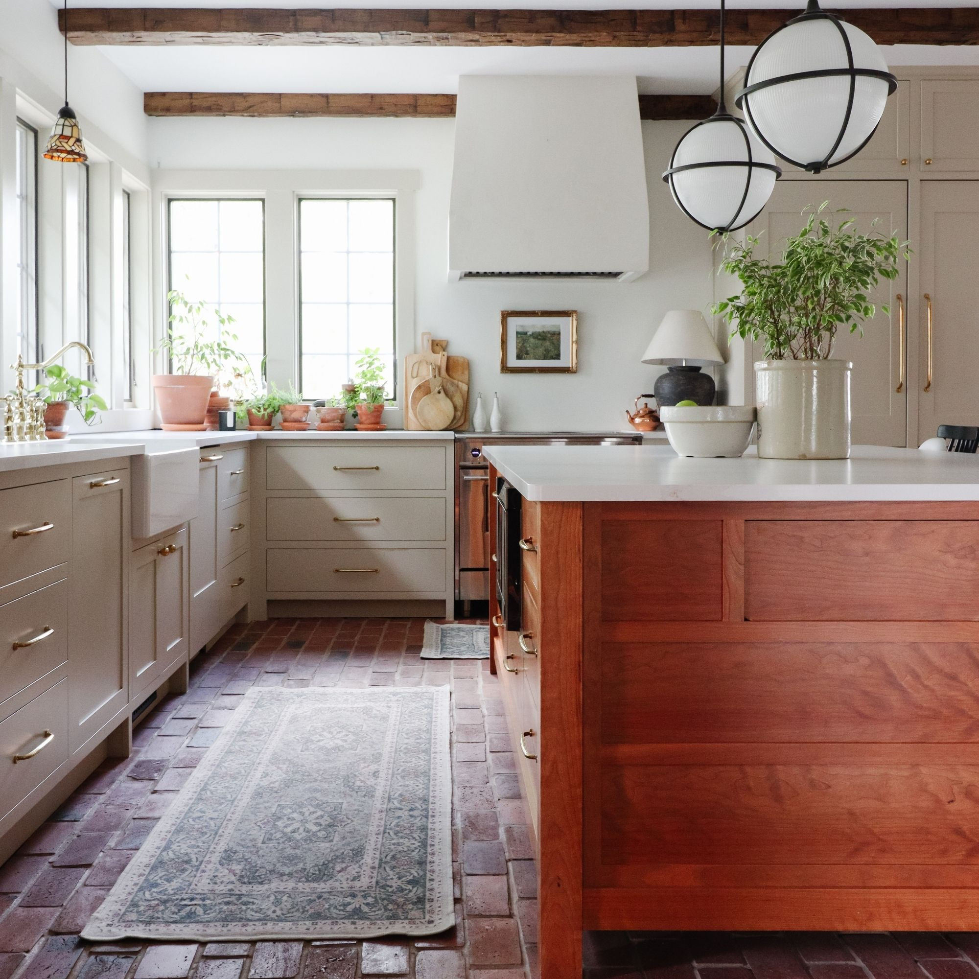 A cozy farmhouse kitchen moment — taupe cabinets, cherry island, and soft brass hardware. Shop the look 👇 

 