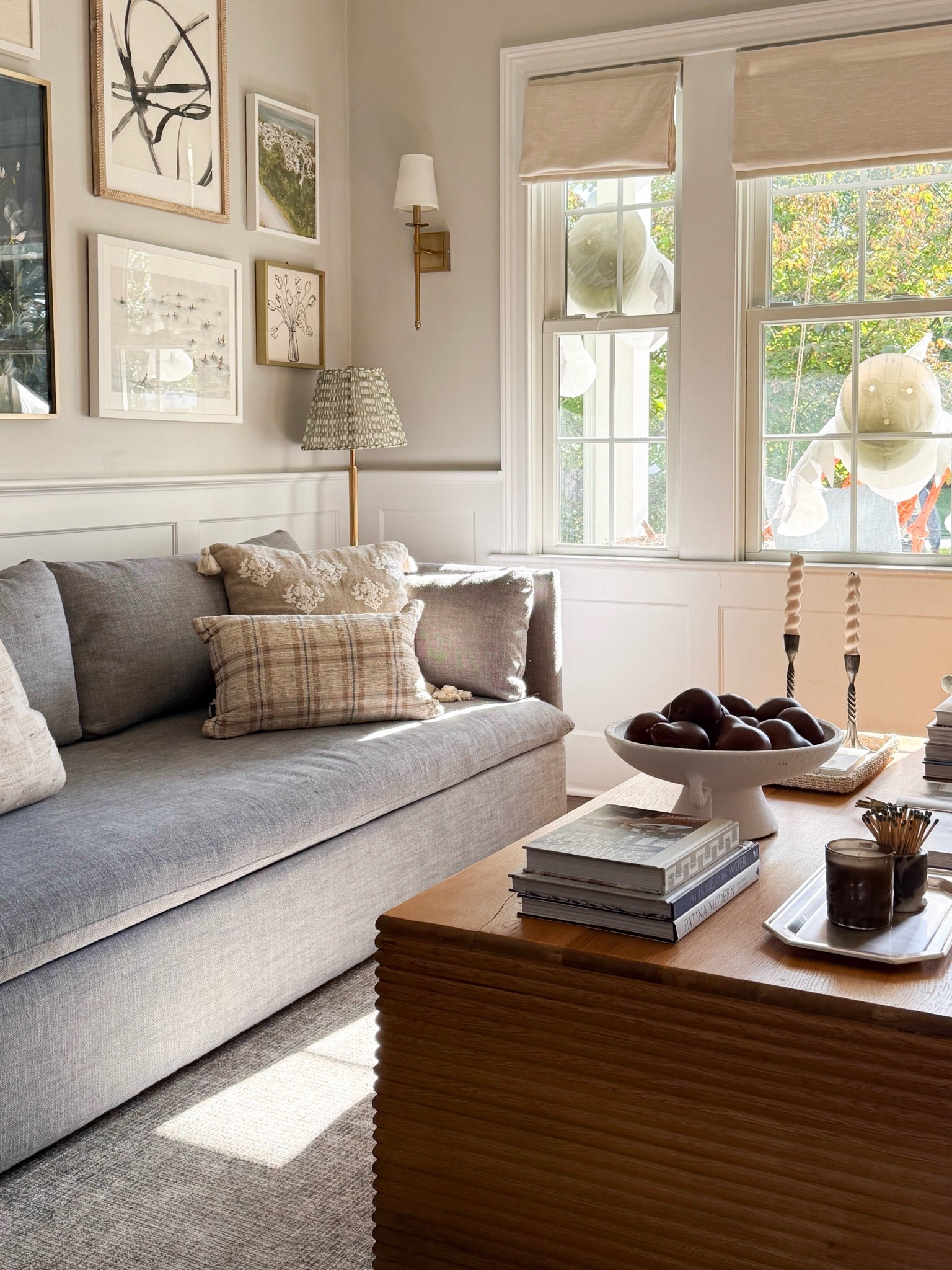 One of my favorite views of our living room lately. I love the mix of soft neutral pillows, warm wood furniture, layered artwork, and collected coffee table decor. A few simple fall touches make the whole space feel so inviting without changing everything.

living room decor, fall living room, coffee table styling, decorative throw pillows, neutral sofa, wood coffee table, fall home decor, gallery wall inspiration, modern coastal home, layered home decor, timeless interiors, girlonthehudson