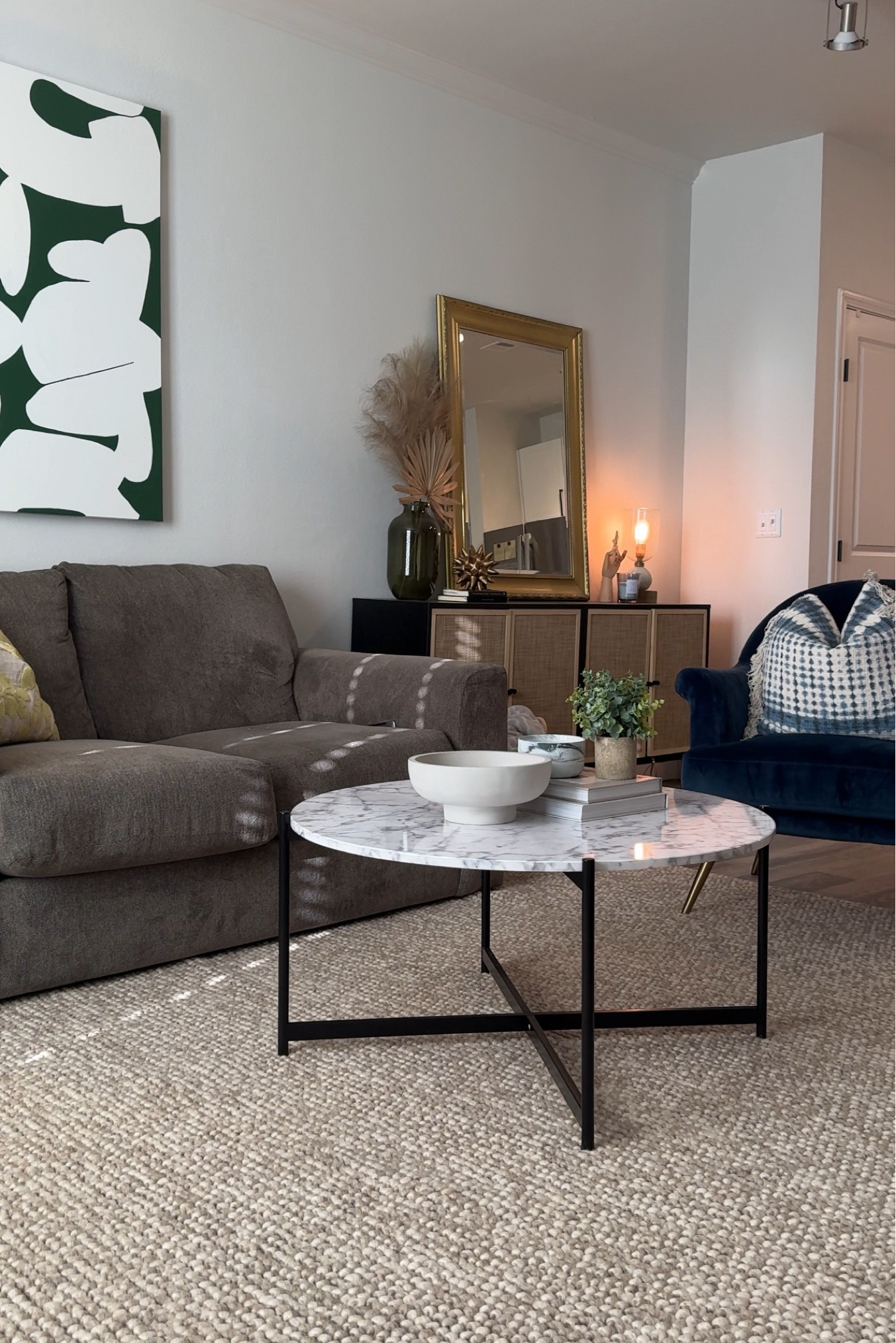 everything in my living room!
couch is old, artwork is my momma’s,blue chair is old target, coffee table is Nathan James discontinued 