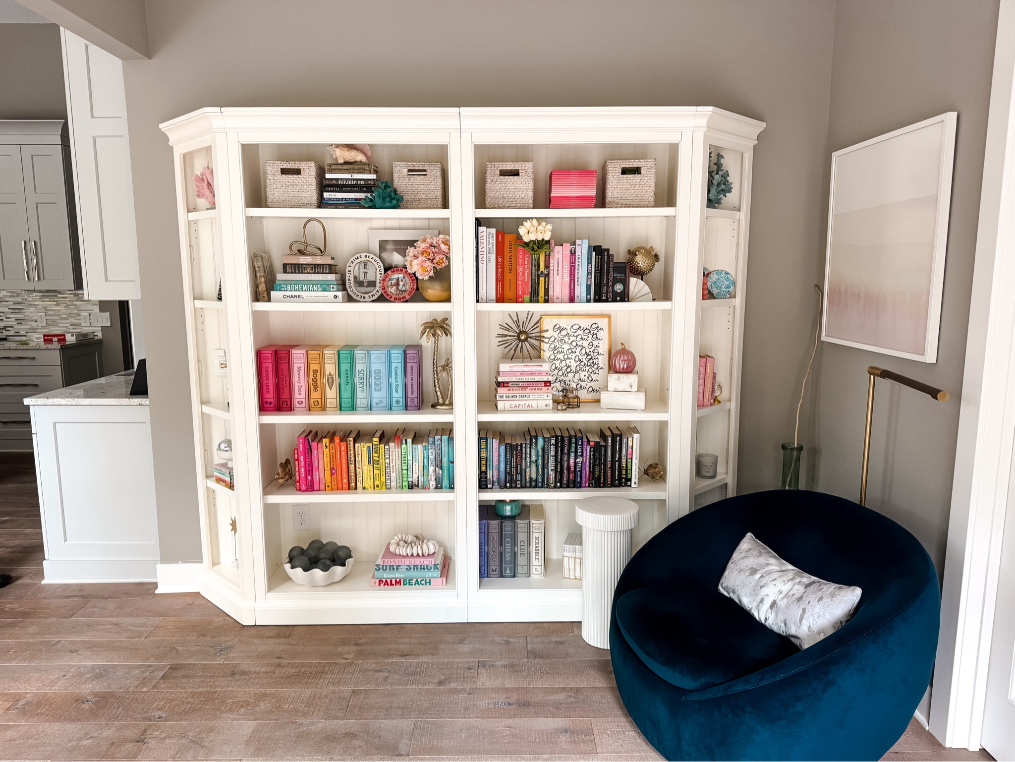 Home decor open shelving 
Bookshelves from pottery barn 
Books and velvety chair 