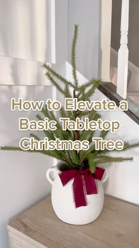 Take a basic table top Christmas tree with a burlap base and put it in a vintage vase or crock. This gives it a styled look and makes it look a little more designer. | Christmas Decorating, Christmas Tree, Christmas Home Tour, Christmas Decor, Christmas Decor Tips, Holiday Home, Neutral Christmas, Designer Look-Alike

#LTKSeasonal #LTKhome #LTKHoliday