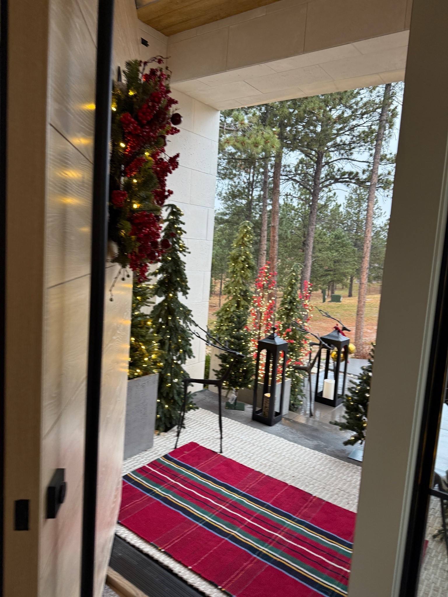 Christmas front porch details. The layered rug look is my favorite! This is the Stewart Plaid rug from Pottery Barn. Linking similar wreaths since this one is out of stock.

#LTKSeasonal #LTKHoliday #LTKHome