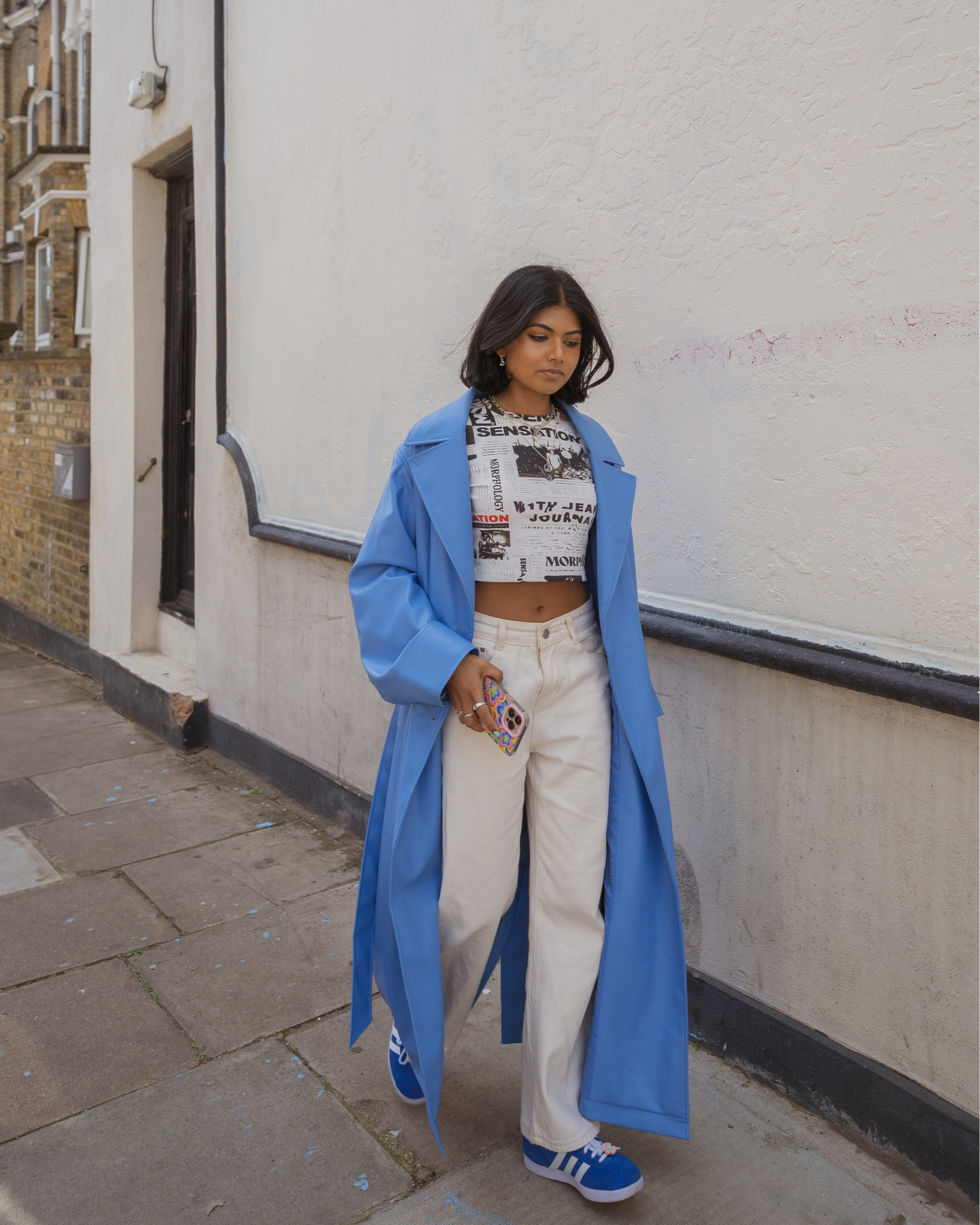 Street style, outfit  ideas, spring looks, wide leg jeans, beige trousers, blue trench coat, leather trench coat, graphic tee, baby tee, crop top, graphic t-shirt, high waisted jeans, adidas gazelle’s, Pandora, Na-kd, Ubran outfitters 

#LTKeurope #LTKSeasonal #LTKfit