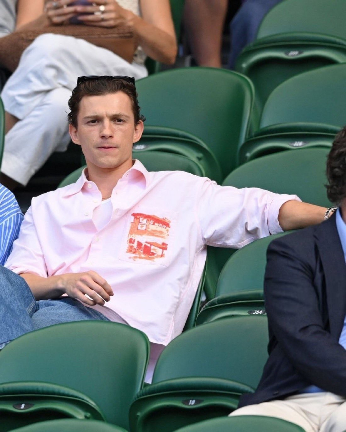 Tom Holland at Wimbledon 2025 wearing a JW Anderson shirt, Sunspel tank top, and Loewe jeans

#LTKSeasonal #LTKMens #LTKStyleTip