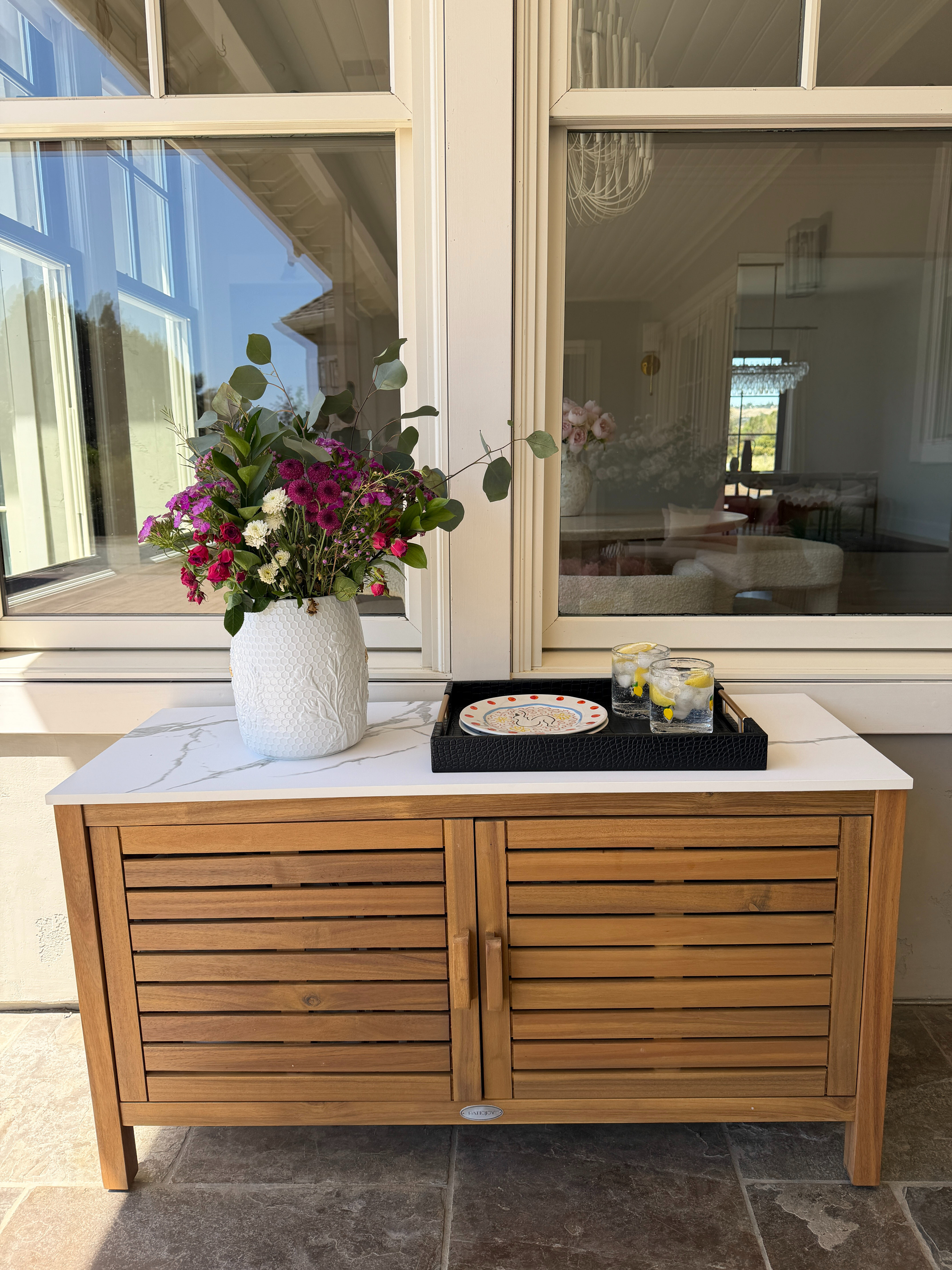 This 2-door acacia wood console table with a faux marble top is a balanced piece of furniture. It offers the elegance of marble, the durability of hardwood, and the practicality of concealed storage, making it both stylish and highly functional in everyday spaces.
Great for patios to provide both storage and surface space.
 

 #LTKHome