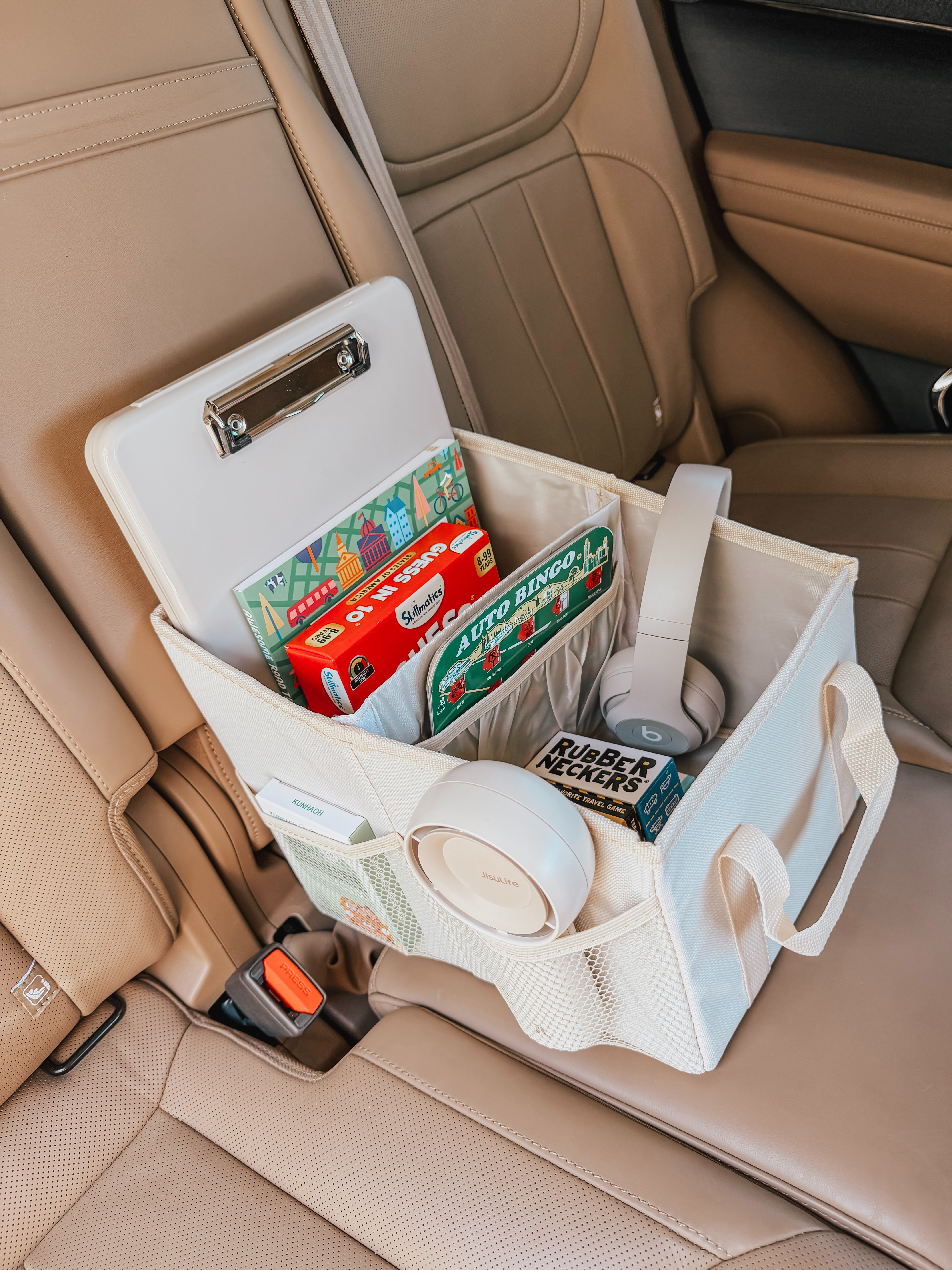 I swear long car rides are so much easier when everything actually has a place. I packed this little road trip survival kit with games that are fun for kids and adults, motion sickness must haves, chargers, snacks, and all the random things everyone always asks for. I love this organizer because you can literally buckle it in with a seatbelt, it stays put, and all the little compartments make everything super easy to reach instead of digging through bags the whole drive. Also obsessed with this cute portable cooler for car snacks, drinks, and easy grab-and-go travel food. 

 #LTKdayinmylife #LTKmomlife #LTKTravel