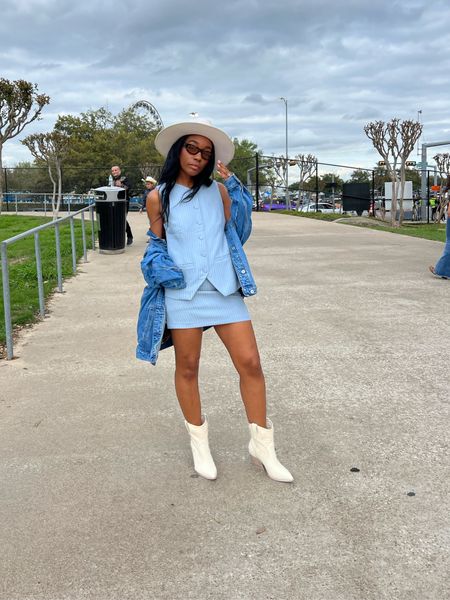 Festival outfit - Blue stripe vest and matching mini skirt set (on sale). Skirt is super short and low rise. Cream boots, denim jacket Country concert outfit:

#LTKFestival #LTKshoecrush #LTKstyletip