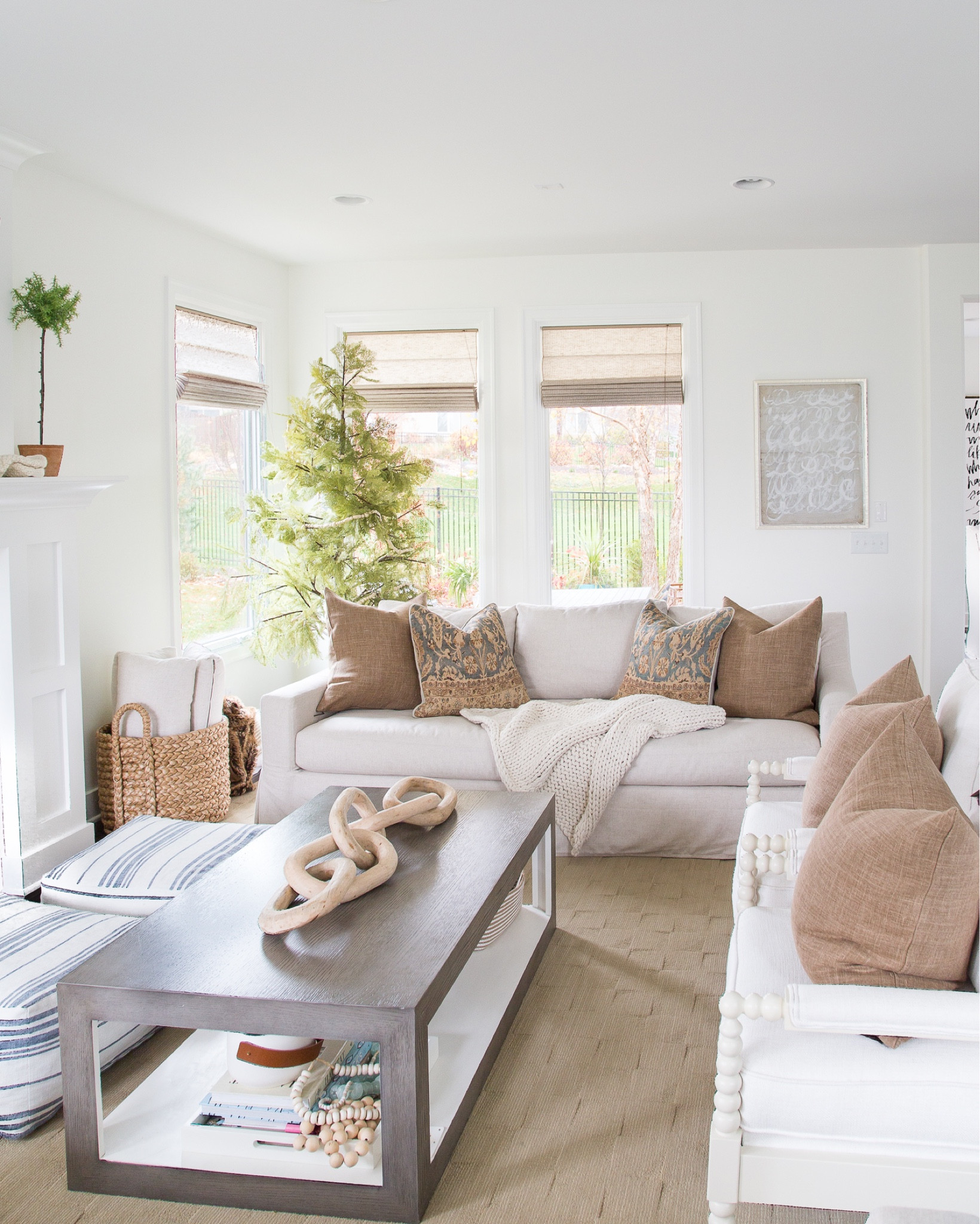 Warm and cozy vibes in our living room!  Items include bronze linen pillows, patterned pillows, a striped throw, slip covered linen sofa, white spindle chairs, wood chain decor, a grey coffee table, faux olive stems, a black console, glass table lamp and wooden picture frames.

simple decor, home decor, fall décor, fall decorating, amazon fall décor, fall home décor, fall pillows, fall target, living room decor, family room décor, targetfanatic, target style, amazon home, amazon finds, walmart home, pottery barn sofa, pottery barn décor, pottery barn inspired living room, den, media room, studio mcgee, fall living room, fall design, target finds, target home, coastal design, master bedroom, coastal bedroom, simple decorating, bedroom decorating #LTKSeasonal #ltkfamily #LTKunder50 #LTKunder100 #LTKhome #LTKstyletip #ltksalealert

#LTKunder100 #LTKsalealert #LTKhome