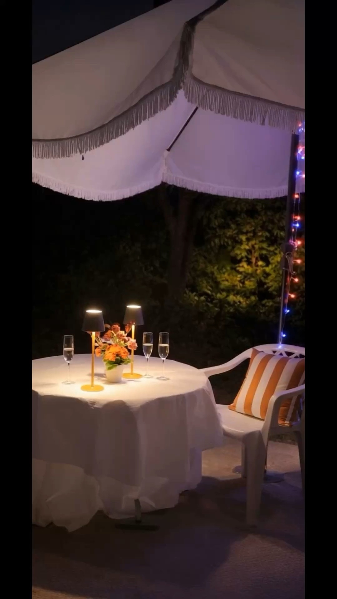 Warm day, backyard chillout.

A quiet corner under a classic French fringe umbrella, where the light slowly softens as the evening settles in. Two rechargeable cordless table lamps add the warmest glow, turning a simple backyard setup into a calm little escape.

Sometimes all you need is a small table, soft lighting, and a peaceful evening outdoors.
#backyardchill
#patiosetup
#frenchumbrella
#fringeumbrella
#cordlesstablelamp
#rechargeablelamp
#patioinspiration
#outdoorliving
#patiochairs
#stripedpillow
#outdoorstyling
#patioideas
#tablecloth #tabkescape #outdoortable #outdoorchair #outdoorpillow

#LTKHome #LTKFestival