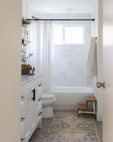 Neutral bathroom design. White shower tile. Vintage inspired runner. 

#LTKhome