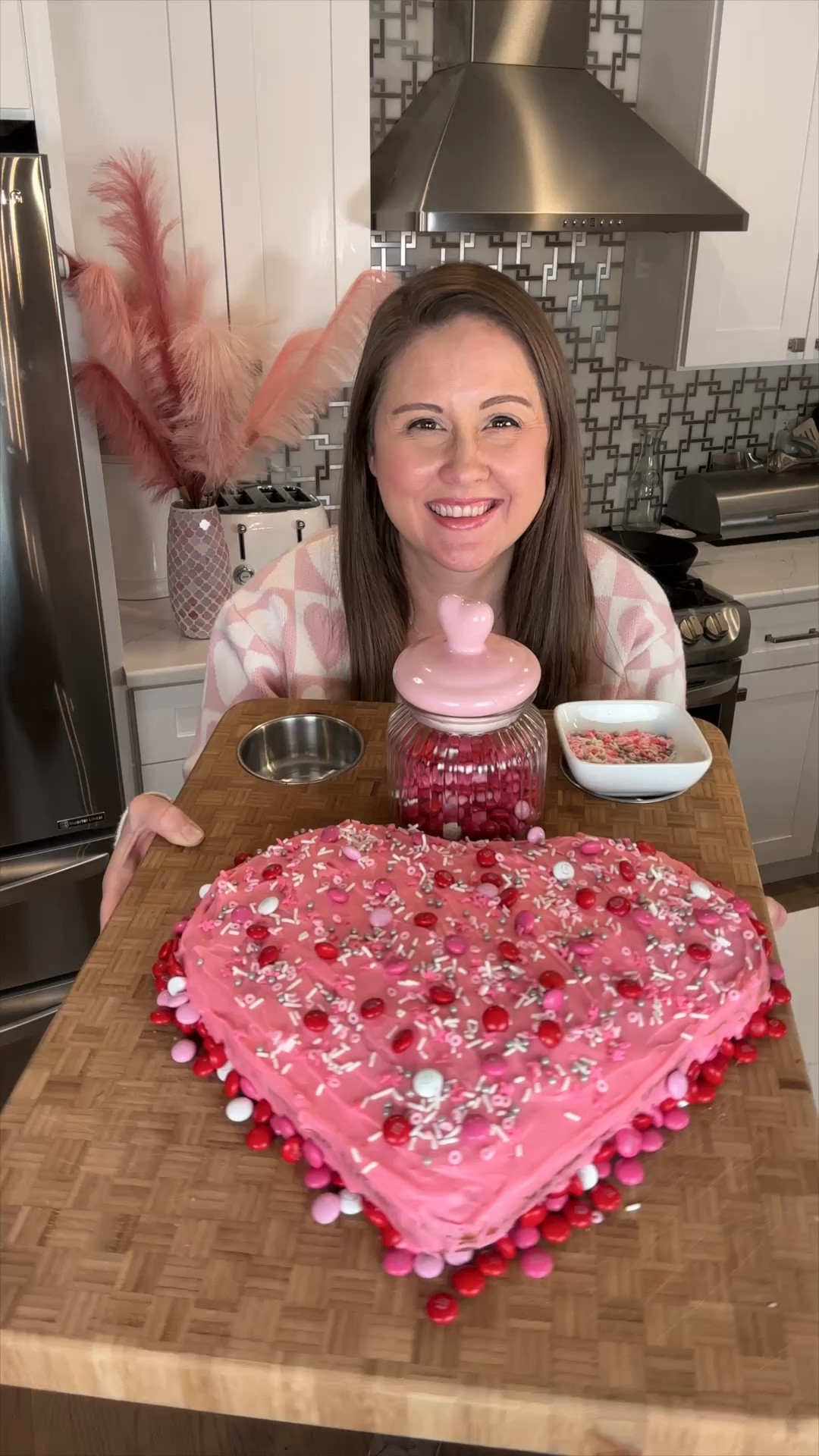 This giant heart shaped cake is easy to make and requires no special pans thanks to this one little trick!  You probably already have what you need at home,  but just in case you’re missing one of the pans I am sharing them with you!  Also sharing my heart sweater! ❤️ #valentinesday #valentinesdaycake #baking 

#LTKhome #LTKSeasonal #LTKfamily