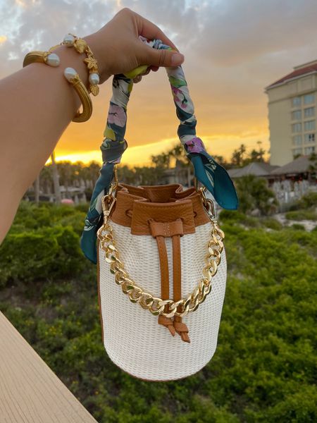 I tied my silk scarf around my bucket bag for a pop of color with my white dress! 
Take 20% OFF my bag with code: HAUTE20
#bucketbag #springstyle #handbag #summerstyle 

#LTKSeasonal #LTKTravel #LTKItBag