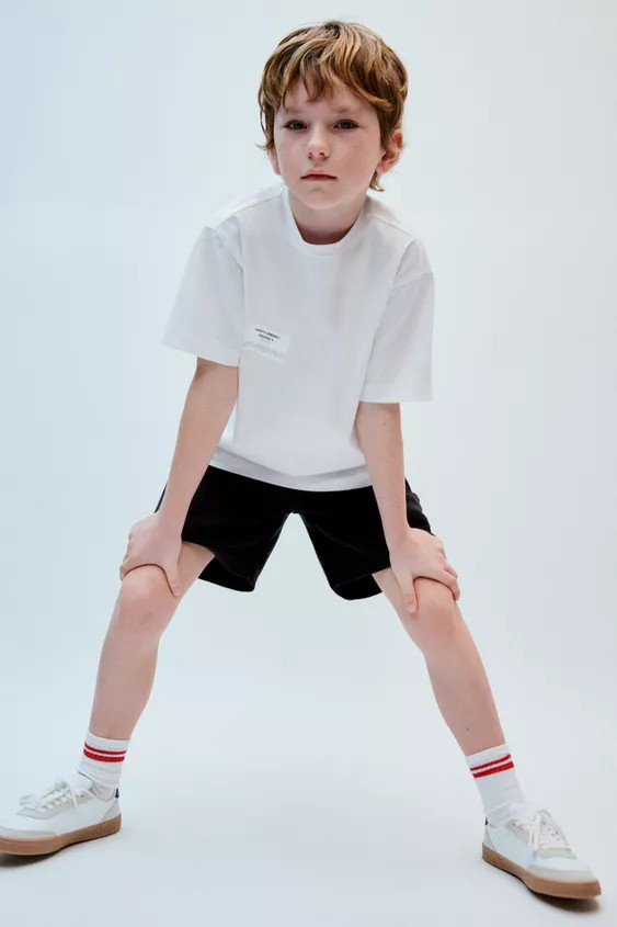 T-shirt with round neck and short sleeves. Embossed text print and label appliqué on the front. ... | Zara US