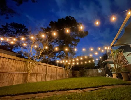 I lit up our outdoor space by rehanging, our outdoor café lights in a zigzag pattern, but this time I upgraded the hangers to heavy duty string light poles that securely stake into the ground. 

I also added water resistant protective covers for the outdoor plug connections. The lights that I am using in the back yard as well as the extension cords are all water resistant however, I have these leftover from waterproofing, holiday, decorations and thought why not put them to use?!

To take it to the next level- I added a smart outdoor plug (which has one of the best apps for controlling smart devices that I have ever used!!). The app allows me to program routines and schedules for my lights to turn on and off, and they can also be controlled by voice using our Alexa devices. In the late evenings, I never have to worry about turning the lights off myself, they will either go off at the time that they are supposed to or when we choose to shut them off. I am a big fan of smart devices inside of my home, it only makes sense to utilize them outside as well!

This has transformed the ambience in our backyard and patio space. The family cannot wait to enjoy the outdoors more during this spring and summer season. 

#LTKhome