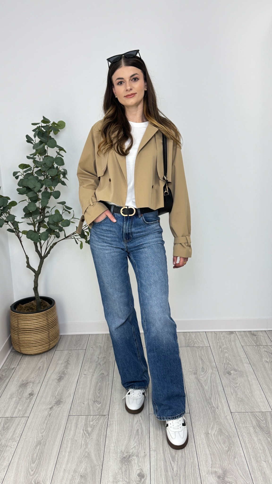 Blue wide-leg jeans, white T-shirt, cropped trench coat, black purse, white sneakers, black belt, sunglasses. A blend of casual comfort and timeless sophistication 🌼 #IlaStylesDiary 

#LTKeurope #LTKworkwear #LTKspring