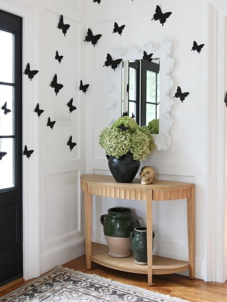 I had some fun with this space during Halloween.  Those are butterflies not bats from Amazon!
The scalloped console table and hand knotted rug are from Target. The terracotta vase and ceramic vase are from Pottery Barn  

#LTKhome #LTKstyletip #LTKFind
