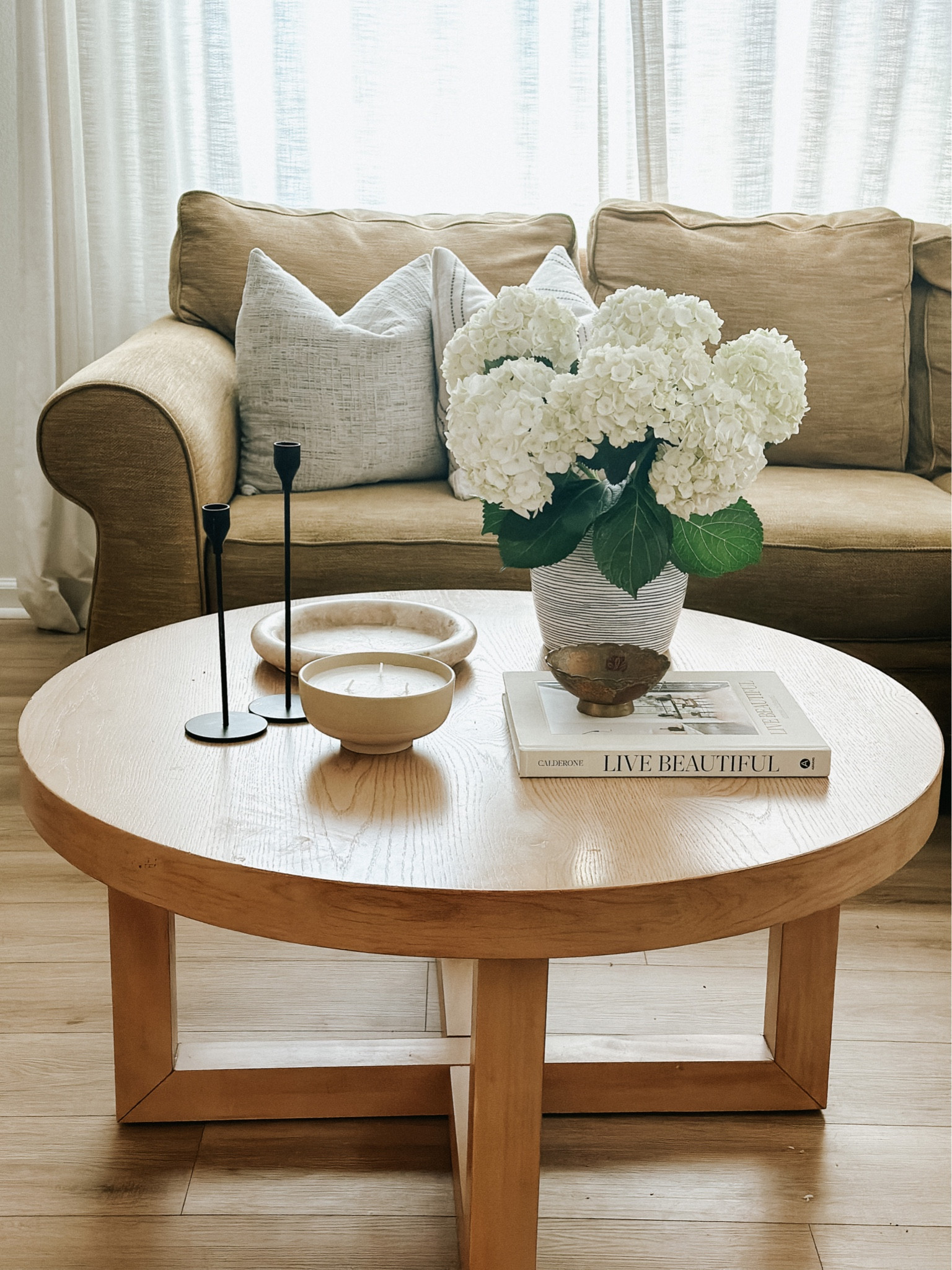 Little signs of spring in my living room round coffee table 